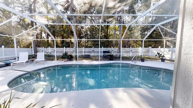 view of swimming pool with a lanai and a patio area