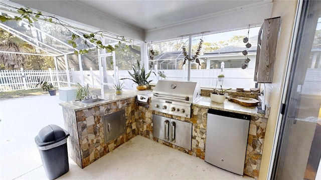 view of patio / terrace featuring a grill, a lanai, sink, and exterior kitchen