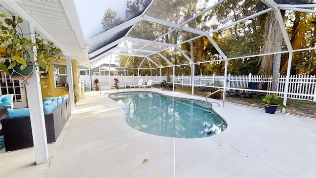 view of pool with glass enclosure and a patio