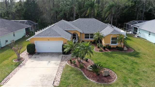 view of front of home featuring a front lawn and a garage