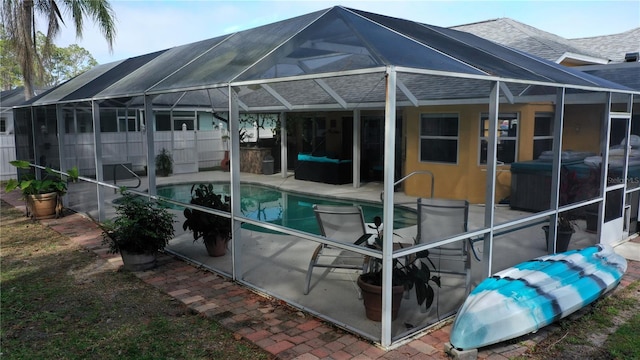 view of swimming pool with a patio and glass enclosure