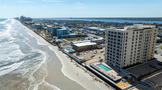 birds eye view of property featuring a beach view and a water view