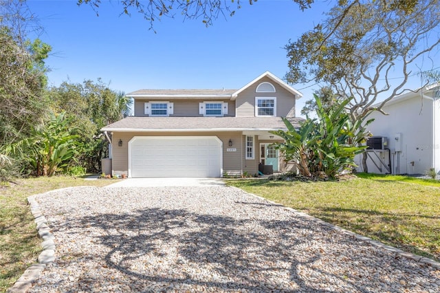 view of front of property featuring a front yard and a garage