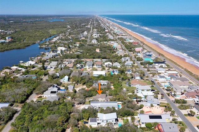 birds eye view of property featuring a water view and a view of the beach