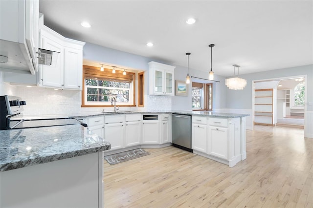 kitchen featuring range, white cabinetry, kitchen peninsula, light hardwood / wood-style flooring, and dishwasher