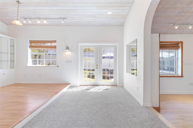 interior space featuring rail lighting, wood ceiling, and french doors