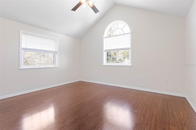 empty room featuring dark hardwood / wood-style flooring, lofted ceiling, ceiling fan, and a wealth of natural light