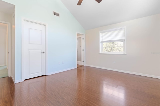 empty room featuring high vaulted ceiling, ceiling fan, and dark hardwood / wood-style floors