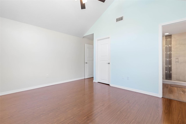 empty room with ceiling fan, dark wood-type flooring, and high vaulted ceiling