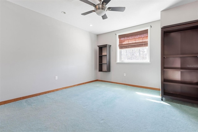 unfurnished bedroom featuring ceiling fan and carpet