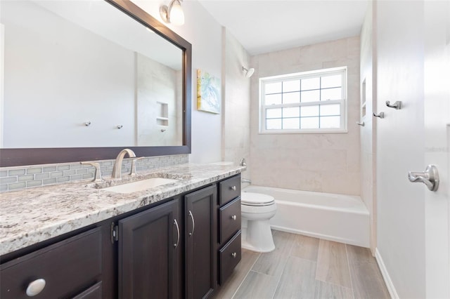 full bathroom with oversized vanity, toilet, and tiled shower / bath combo