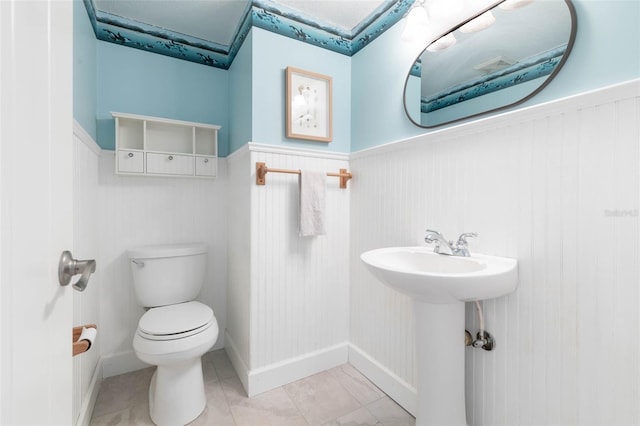 bathroom with tile flooring and toilet