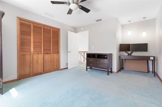 bedroom with a closet, light colored carpet, and ceiling fan