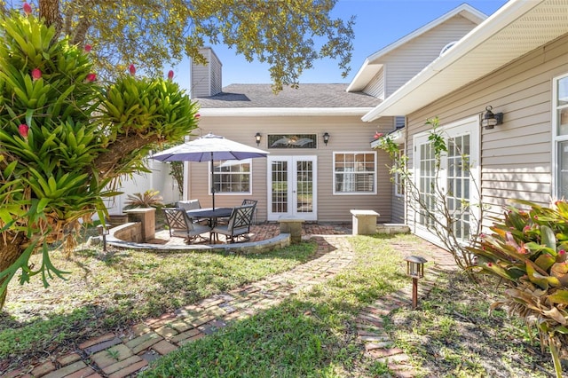 rear view of property featuring a patio and french doors