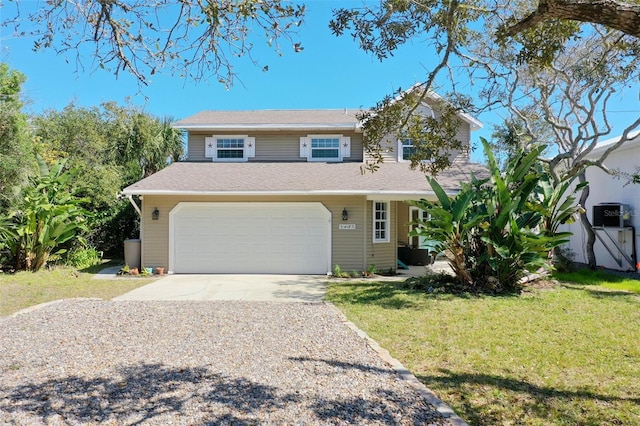 view of front of house featuring a front lawn and a garage