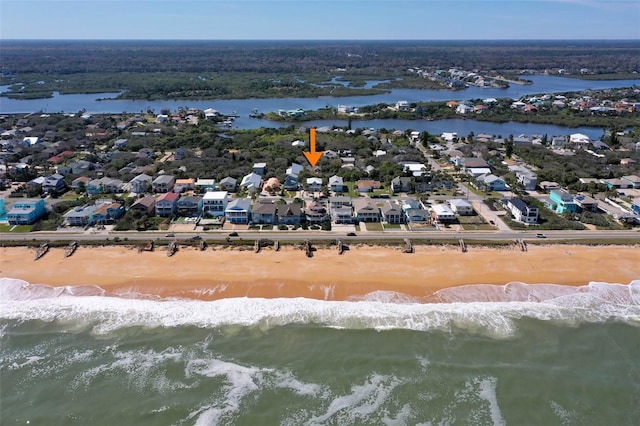 drone / aerial view with a water view and a view of the beach