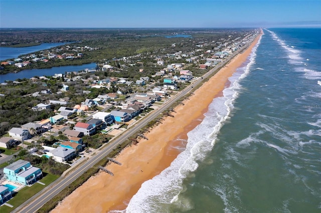 birds eye view of property featuring a view of the beach and a water view