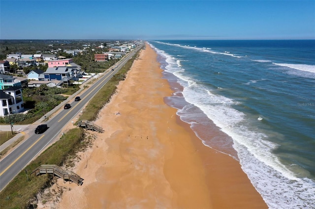 birds eye view of property featuring a water view and a view of the beach