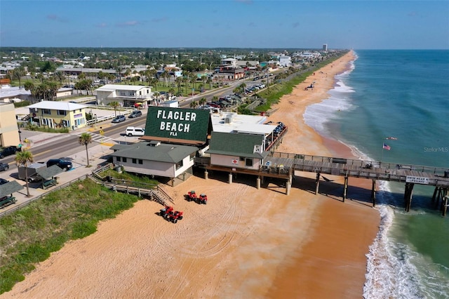 birds eye view of property featuring a water view and a view of the beach