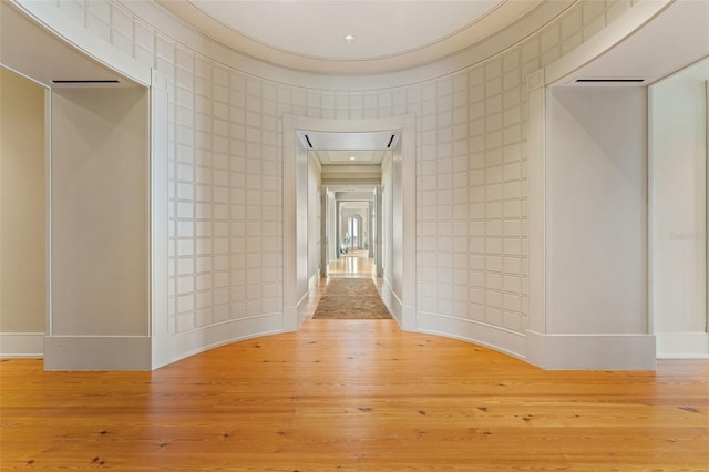 corridor with light hardwood / wood-style flooring