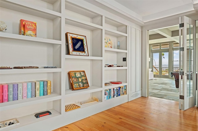 interior space featuring built in shelves, french doors, and hardwood / wood-style floors