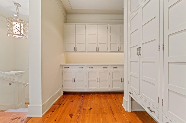 interior space featuring crown molding and light hardwood / wood-style floors