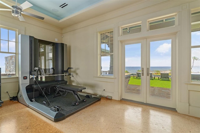 interior space featuring ceiling fan, a water view, a wealth of natural light, and french doors