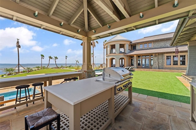 view of patio / terrace featuring a gazebo, a grill, and a water view