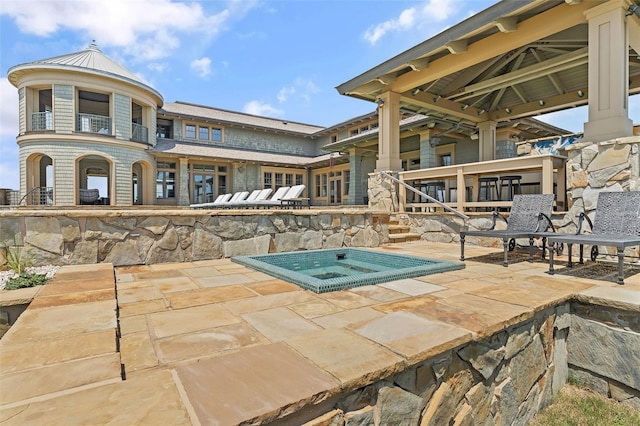 view of swimming pool featuring an in ground hot tub and a patio