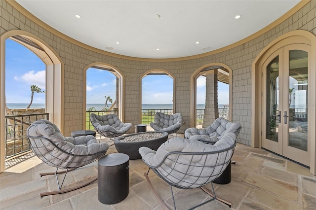 view of patio / terrace featuring a water view and french doors