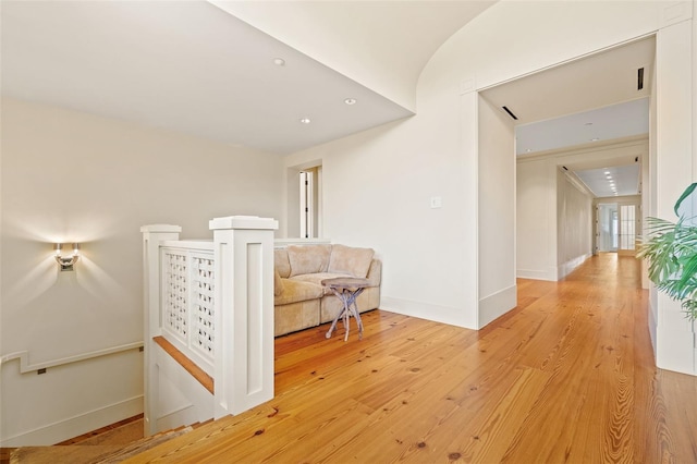 corridor with light hardwood / wood-style floors