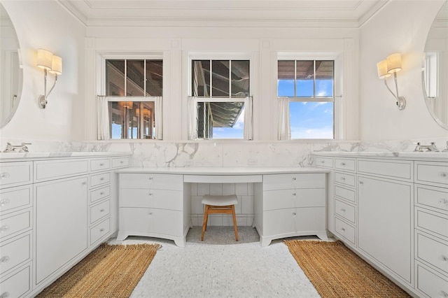 bathroom featuring ornamental molding and vanity