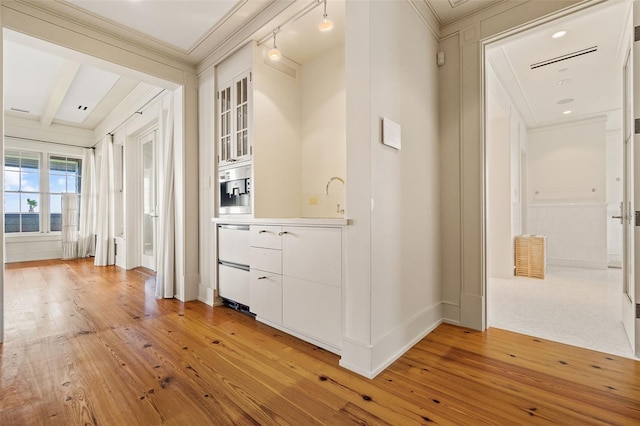 corridor featuring wood-type flooring, sink, crown molding, and beam ceiling