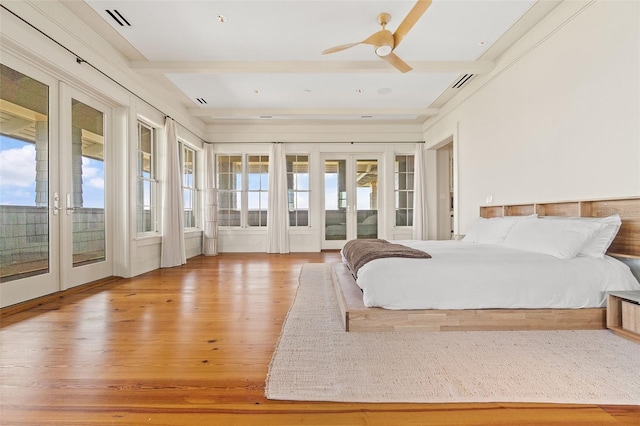 bedroom featuring ceiling fan, light hardwood / wood-style flooring, french doors, and access to exterior