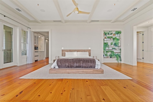 unfurnished bedroom with beam ceiling, multiple windows, ceiling fan, and hardwood / wood-style floors