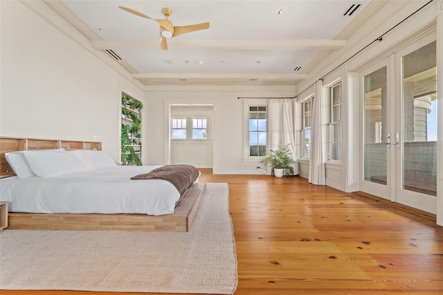 bedroom with access to exterior, ceiling fan, wood walls, and hardwood / wood-style floors