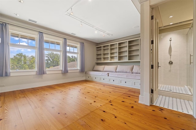 mudroom with crown molding and light hardwood / wood-style floors