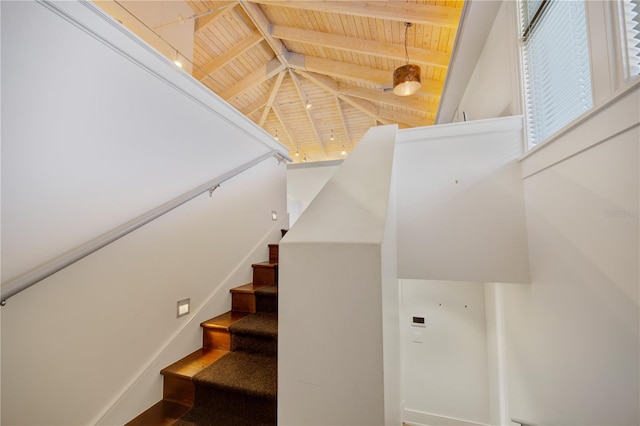 staircase with vaulted ceiling with beams and wood ceiling