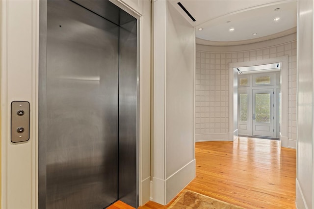 bathroom featuring wood-type flooring and elevator