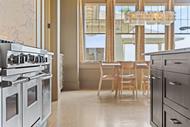 kitchen featuring range with two ovens and plenty of natural light