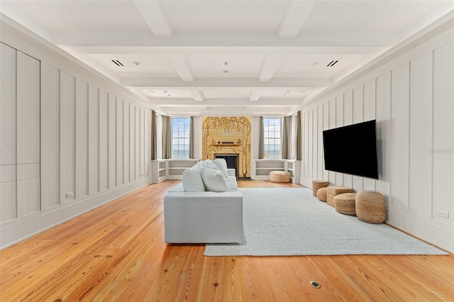 living room featuring wood-type flooring and beamed ceiling