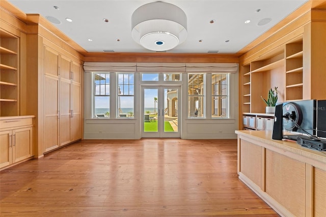 interior space featuring light wood-type flooring, built in features, and french doors