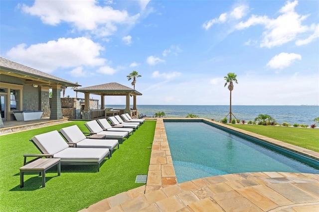 view of pool with a gazebo, a water view, a patio, and a lawn