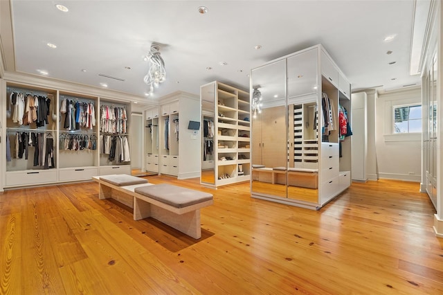 interior space with ornamental molding and light hardwood / wood-style flooring