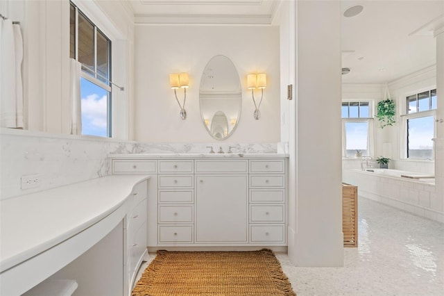 bathroom featuring ornamental molding, a washtub, and vanity