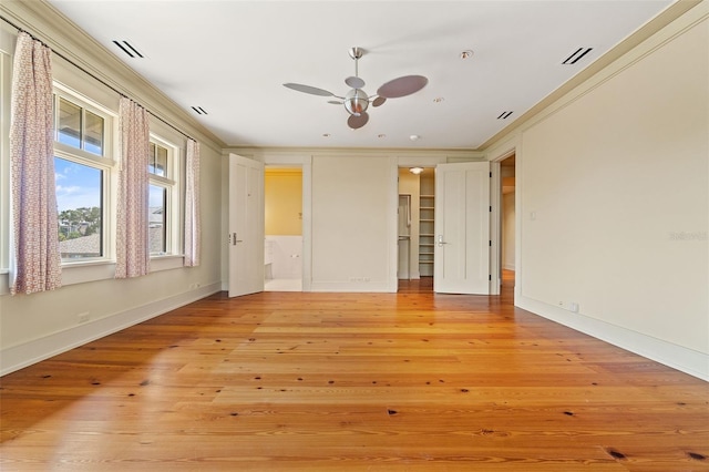 interior space with ceiling fan, ornamental molding, and light hardwood / wood-style floors