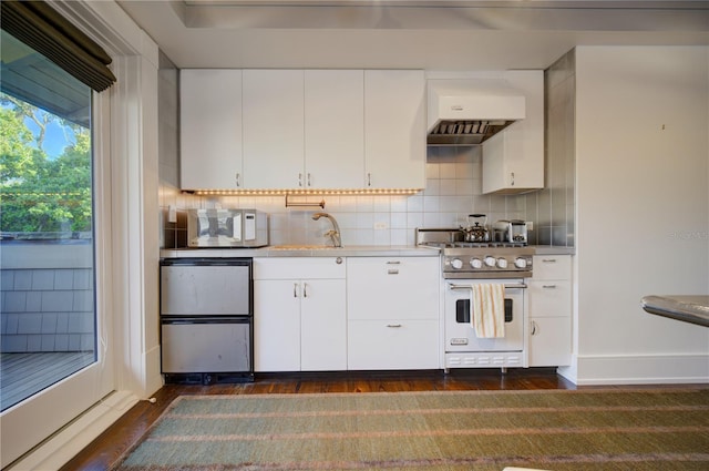 kitchen featuring white cabinets, dark hardwood / wood-style floors, white appliances, and decorative backsplash