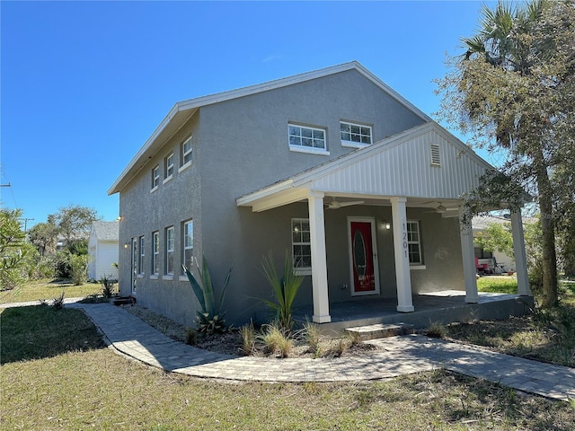 view of front of house featuring covered porch and a front yard