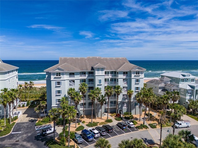 view of property featuring uncovered parking and a water view