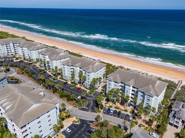 drone / aerial view with a water view and a beach view